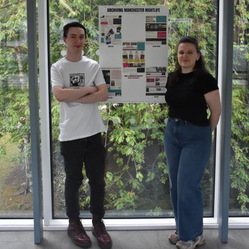 Callum Henry standing beside a presentation of his research.